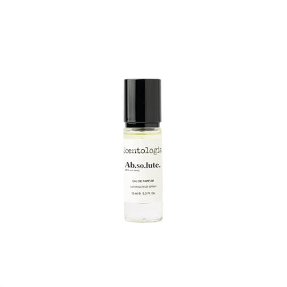 A 10 ml clear glass bottle of Scentologia Ab.so.lute. Eau de Parfum with amber musk notes and a black cap, labeled Scentologia, is photographed against a white background.