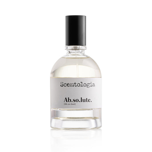 A clear glass bottle with a black cap labeled Scentologia and Ab.so.lute. Eau de Parfum sits on a white background, its transparent liquid hinting at an amber musk and sensual vanilla oriental scent by Scentologia.