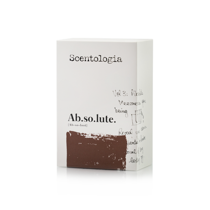 A white rectangular box labeled Scentologia features “Ab.so.lute. Eau de Parfum” in bold black text, handwritten notes and doodles on the side, and a brown brushstroke below that evokes sensual vanilla and amber musk.