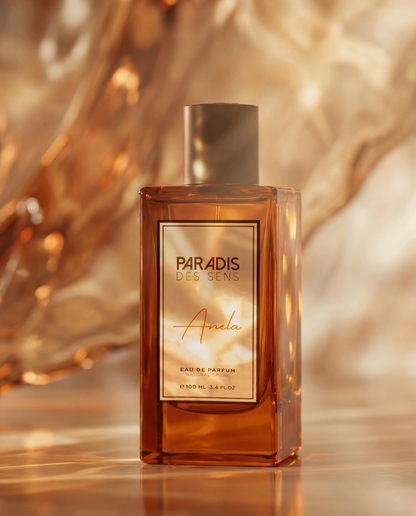 Paradis des Sens perfume bottle with a gold and bronze gradient background