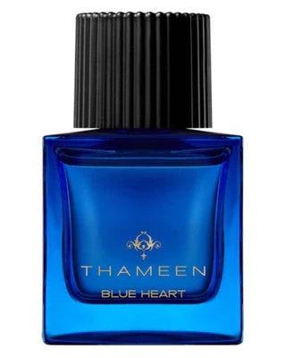 A square blue glass bottle of Fragrapedia Haus Blue Heart Extrait de Parfum by Thameen London, featuring a black ribbed cap and gold text on the front, reflects the allure of this ambery "blue diamond" fragrance.
