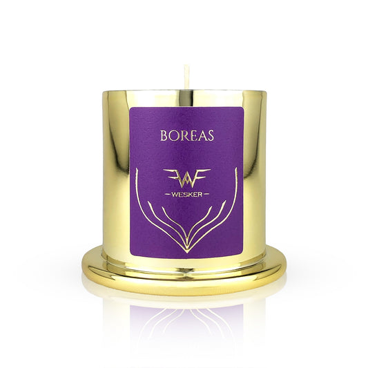 The Boreas Candle - Wesker by Wesker features a gold metallic artisan jar with a purple label, gold design, and matching base. The hand-poured candle is shown lit against a white background.