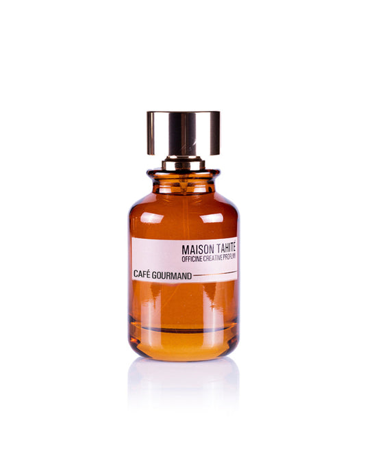 Café Gourmand Eau de Parfum by Maison Tahité comes in a brown glass bottle with a shiny gold cap. Its rich scent evokes hazelnut coffee and smoky wood, perfect for lovers of warm, inviting aromas.