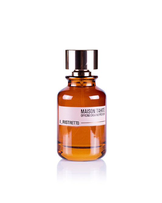 A brown glass bottle with a shiny gold cap, labeled “I Ristretto Eau de Parfum - Maison Tahite,” hints at the rich Coffee Absolute Arabica aroma by Maison Tahite, set against a white background.