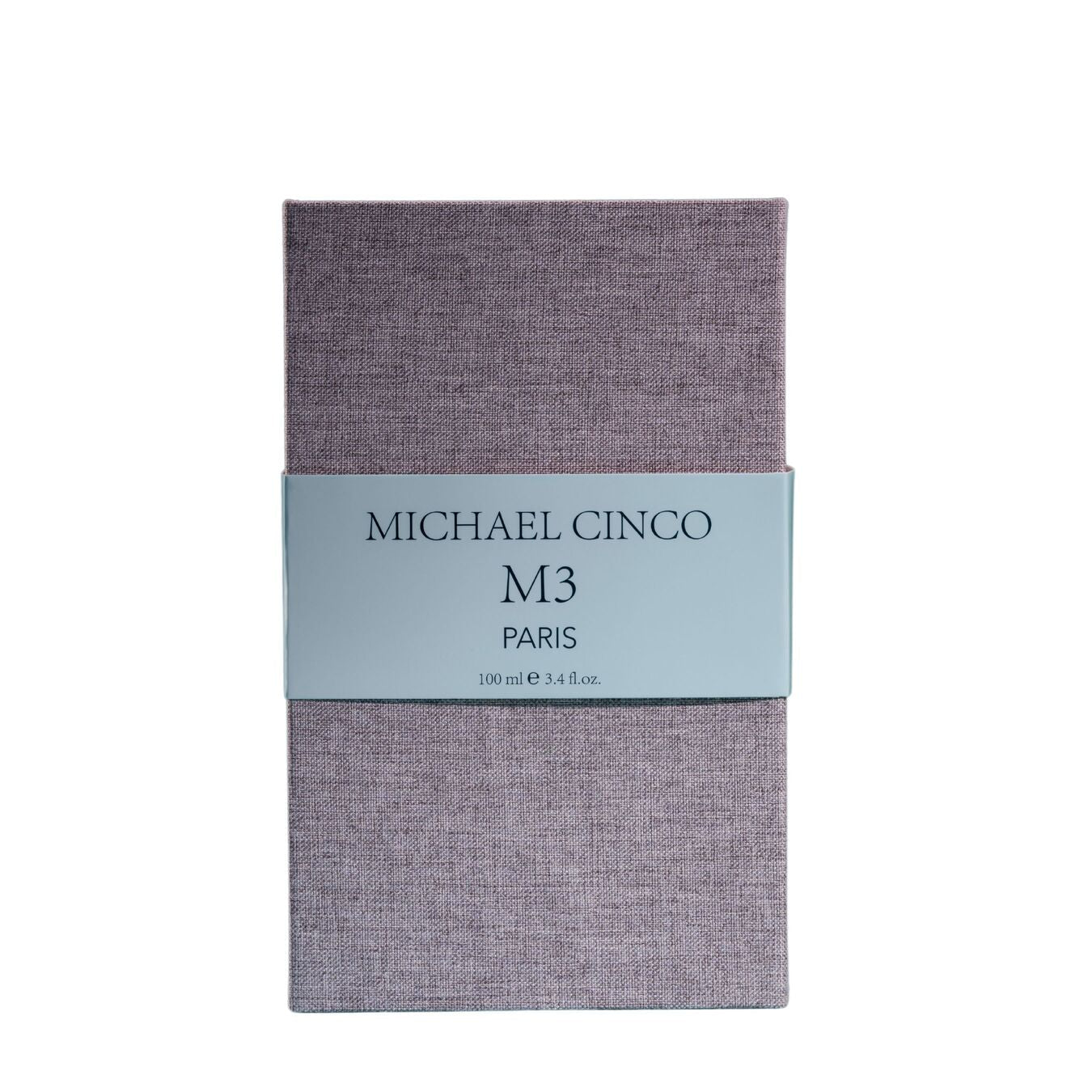 A rectangular box with a textured lavender surface and a light gray label reading Fragrapedia Haus M3 Eau de Parfum 100 ml, suggesting a floral scent created by Michael Cinco with consciously sourced ingredients.