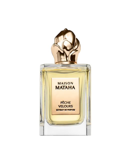 A clear glass bottle of Fragrapedia Haus Pêche Velours Extrait de Parfum, featuring a gold rose-shaped cap and light yellow liquid, evokes a velvety peach summer scent against a white background.