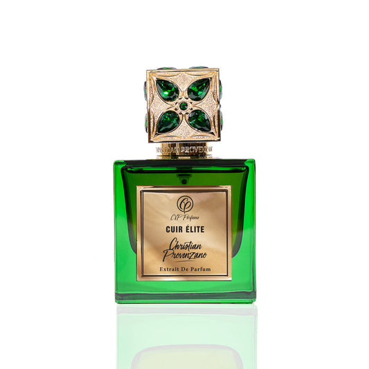 A green glass bottle with a gold label reading Cuir Elite Eau de Parfum by Christian Provenzano features an ornate gold cap accented with green gems, emphasizing the fragrance’s luxury against a crisp white background.