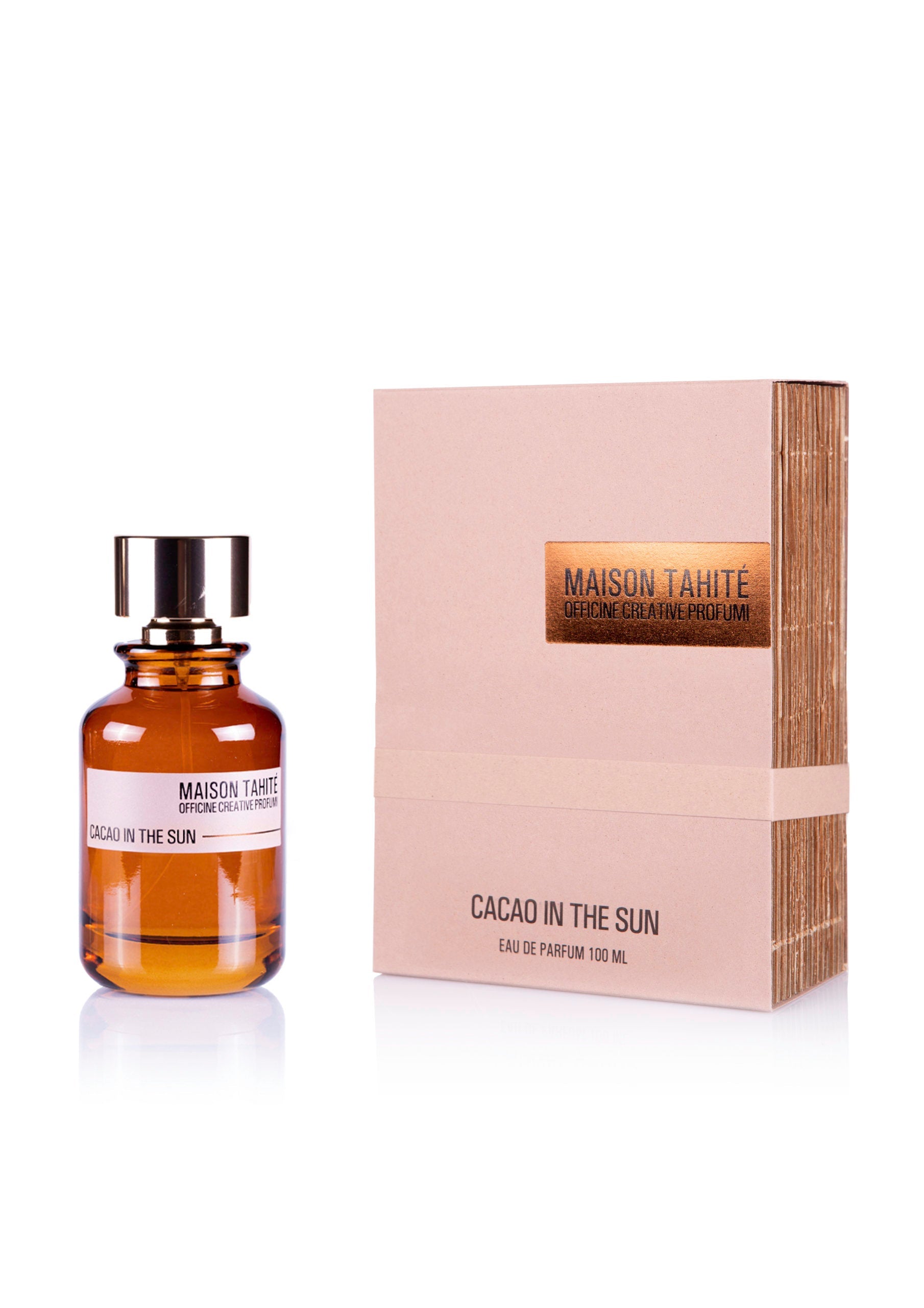 A brown glass bottle of Cacao in the Sun Eau de Parfum by Maison Tahite stands beside its beige box, which features the product name and brand in gold and brown text.