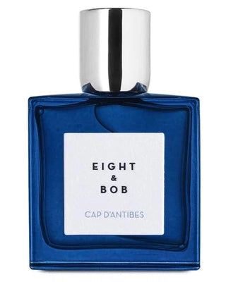 A blue glass bottle of Cap d'Antibes Eau de Parfum by Fragrapedia Haus, featuring a silver cap and white label with black lettering—a perfect luxury fragrance for summer.