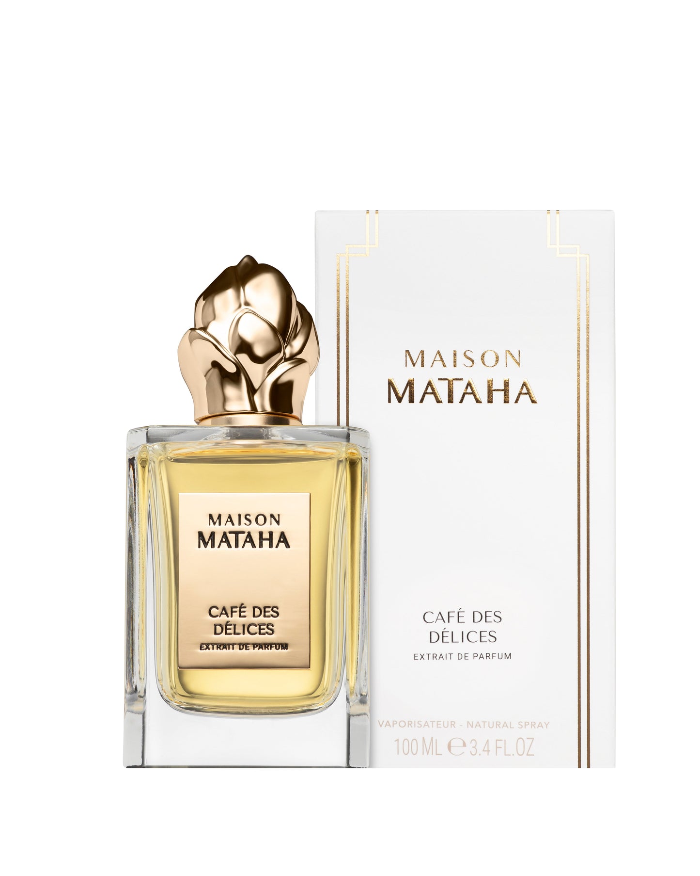 A bottle of Maison Mataha Café des Délices Extrait de Parfum, a coffee fragrance with vanilla musk notes, stands before its white and gold box. Both the bottle and packaging feature the Maison Mataha brand and product name.