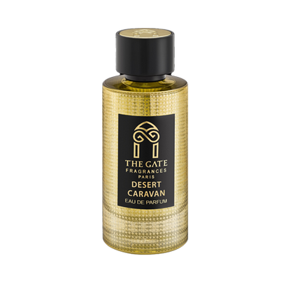 A gold textured bottle with a black cap and label reading "The Gate Paris Desert Caravan Eau de Parfum" captures the oriental spicy scent of oud and musk by The Gate Paris.