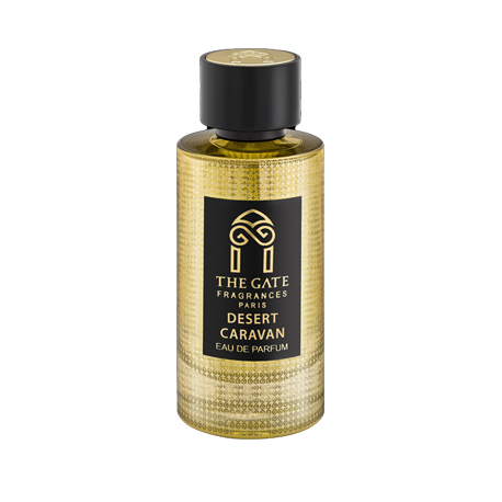 A gold textured bottle with a black cap and label reading "The Gate Paris Desert Caravan Eau de Parfum" captures the oriental spicy scent of oud and musk by The Gate Paris.