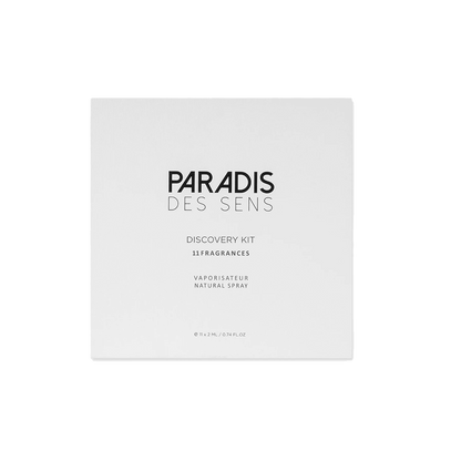 A white box labeled "Discovery Set - Paradis Des Sens" by PARADIS DES SENS rests on a plain background. Explore 11 unique fragrances in this elegant set to find your signature scent.