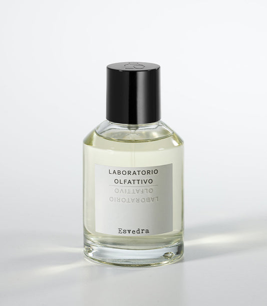 A clear glass Laboratorio Olfattivo perfume bottle labeled "Esvedra - Laboratorio Olfattivo," inspired by the mysterious Mediterranean island of Es Vedra, with a black cap, shot on a plain white background.