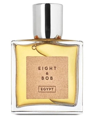 A clear glass bottle with yellow perfume and a silver cap features a tan label reading EIGHT & BOB EGYPT, by Fragrapedia Haus. The Egypt Eau de Parfum hints at an exotic scent inspired by ancient Egyptian perfumery.