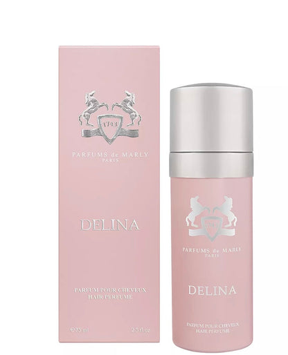 A pink bottle and matching box of Parfums de Marly Delina Hair Mist, a luxurious 75 ml (2.5 fl oz) hair fragrance featuring silver text and crest logo, labeled DELINA and Parfum pour cheveux.