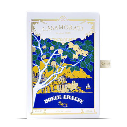Box of XERJOFF Casamorati 1888 Dolce Amalfi Eau de Parfum (100ml) with a coastal scene—lemons, blue sea, cliffs, sailboat, and gold-trimmed label. This scent delights with oriental spicy notes.