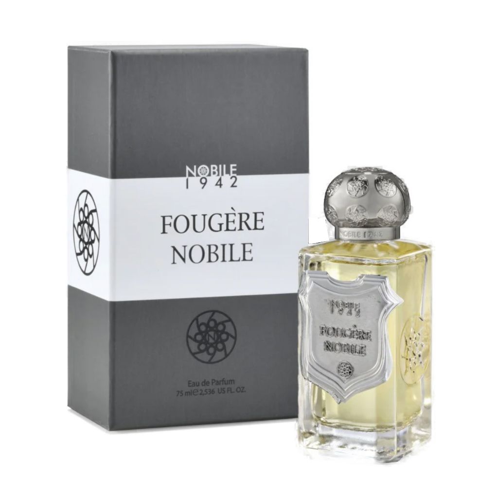 A bottle of Nobile 1942 FOUGERE NOBILE Eau de Parfum, containing light yellow liquid and topped with a silver cap, sits next to its gray and white box. The men's fragrance features an elegant label and a classic fougère accord.