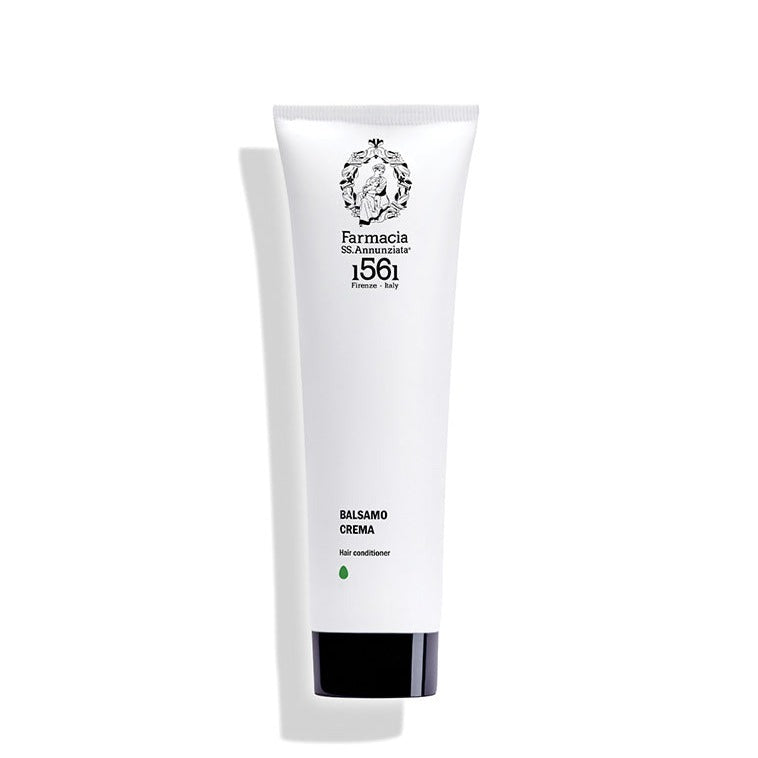 A white tube of Farmacia SS. Annunziata 1561 Hair Conditioner "BALSAMO CREMA" with black text and logo stands upright against a white background, casting a left shadow.
