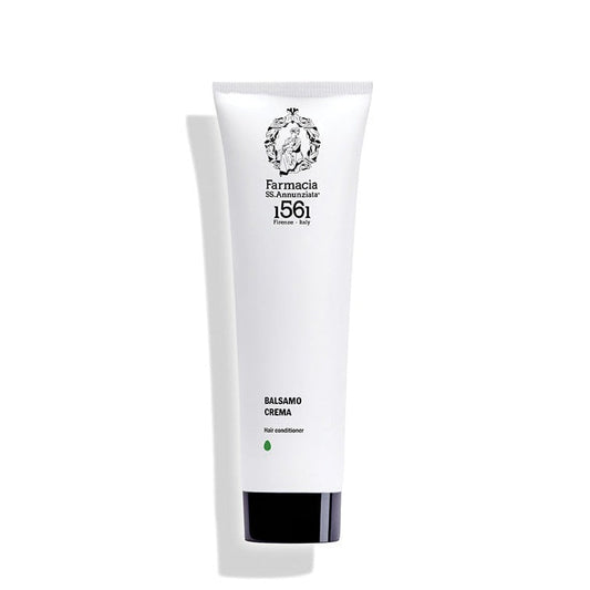 A white tube of Farmacia SS. Annunziata 1561 Hair Conditioner "BALSAMO CREMA" with black text and logo stands upright against a white background, casting a left shadow.