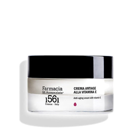 A jar of Farmacia SS. Annunziata 1561 Anti-aging cream with vitamin E "CREMA ANTIAGE ALLA VITAMINA E," designed for mature skin, features a black lid and a white label with black text.