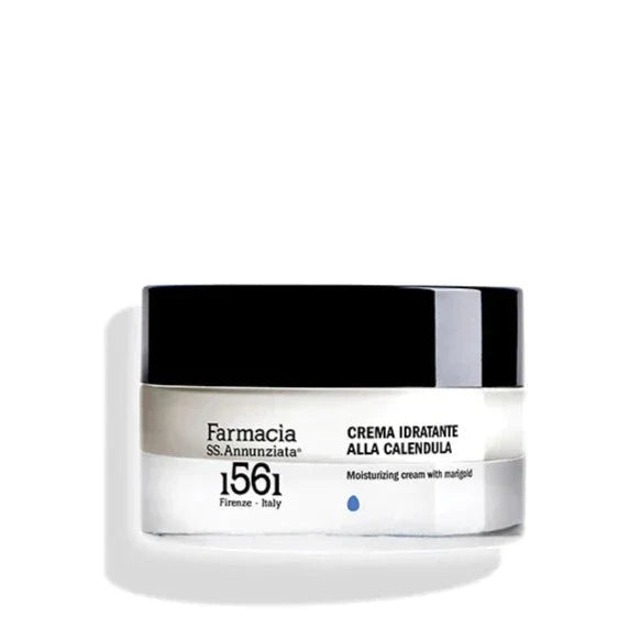 A white and black jar of Farmacia SS. Annunziata 1561 Moisturizing Cream with Marigold "CREMA IDRATANTE ALLA CALENDULA," a moisturizer for sensitive skin, displayed against a plain white background.