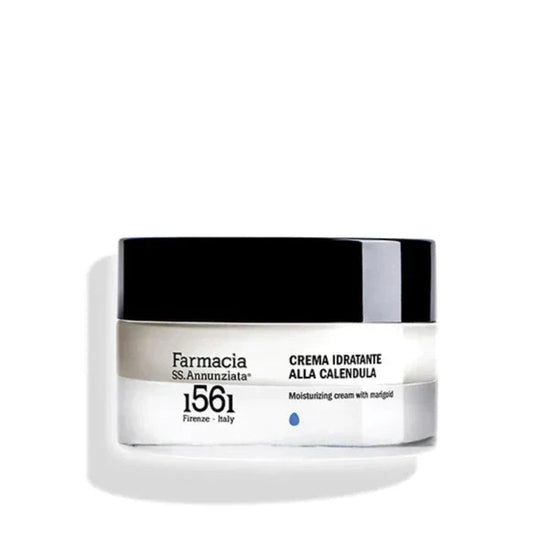 A white and black jar of Farmacia SS. Annunziata 1561 Moisturizing Cream with Marigold "CREMA IDRATANTE ALLA CALENDULA," a moisturizer for sensitive skin, displayed against a plain white background.