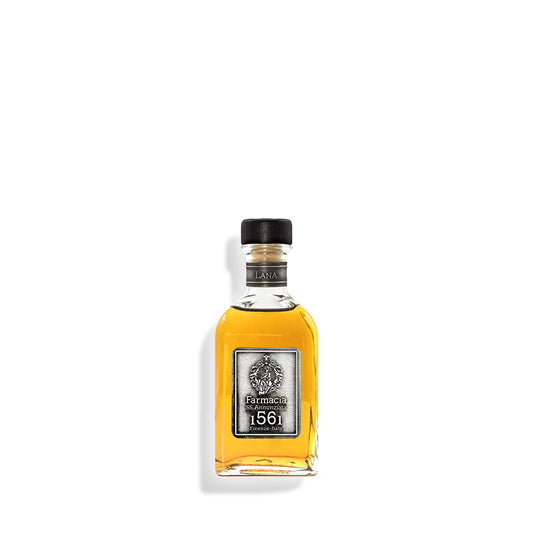 A small rectangular glass bottle filled with amber liquid, featuring a black cap and a silver label that reads Farmacia 1561. The Lana DIFFUSER by Farmacia SS. Annunziata 1561 is shown against a white background.