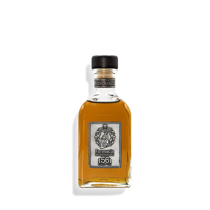 The Mercatanti Diffuser by Farmacia SS. Annunziata 1561 features a clear glass bottle with amber liquid, black cap, and silver label with an embossed emblem—an elegant home fragrance perfect as an ambient diffuser.