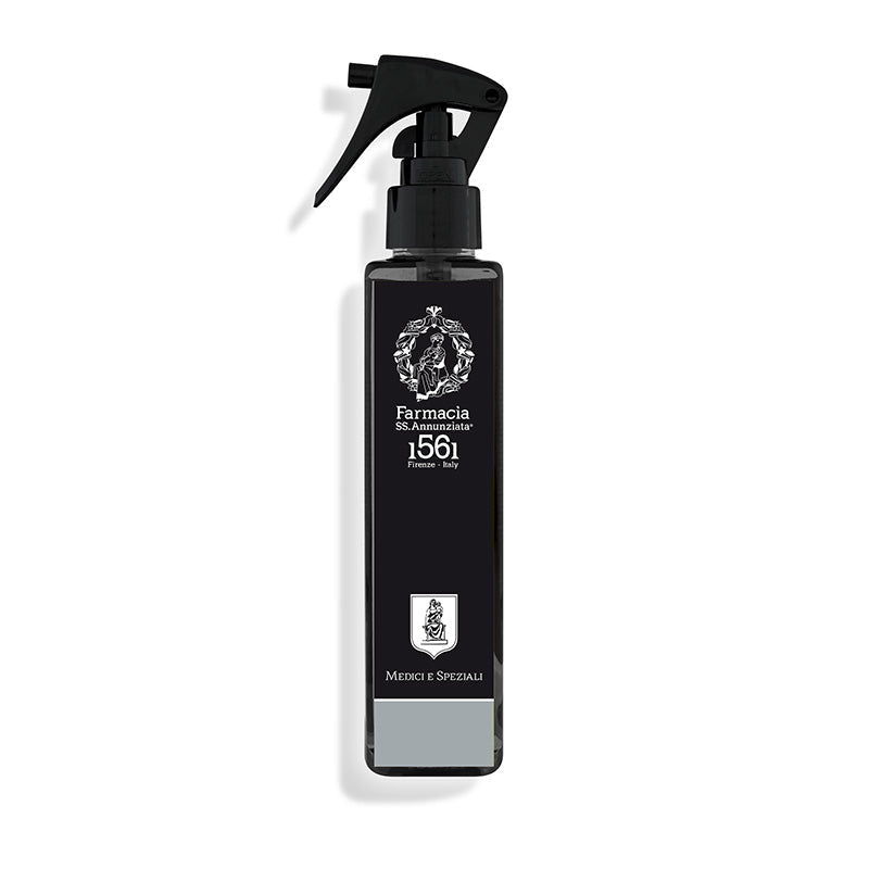 The Medici e Speziali Room Spray by Farmacia SS. Annunziata 1561 features a sleek black bottle with a white emblem—ideal for adding an elegant, Italian-inspired fragrance to any room.