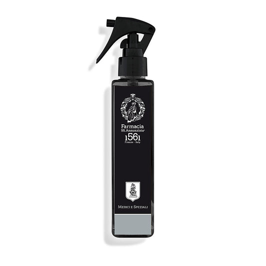 The Medici e Speziali Room Spray by Farmacia SS. Annunziata 1561 features a sleek black bottle with a white emblem—ideal for adding an elegant, Italian-inspired fragrance to any room.