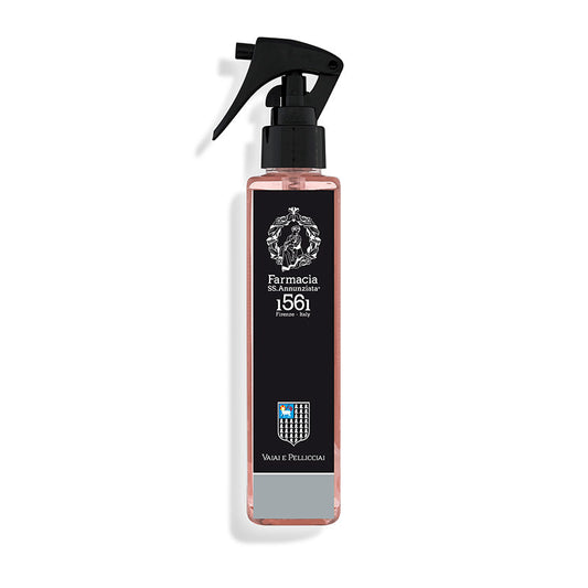 The Vaiai e Pellicciai Room Spray by Farmacia SS. Annunziata 1561 comes in a tall, clear bottle with pink liquid, black label, crest, and shield—ideal for infusing spaces with a fresh floral scent. Made in Italy.