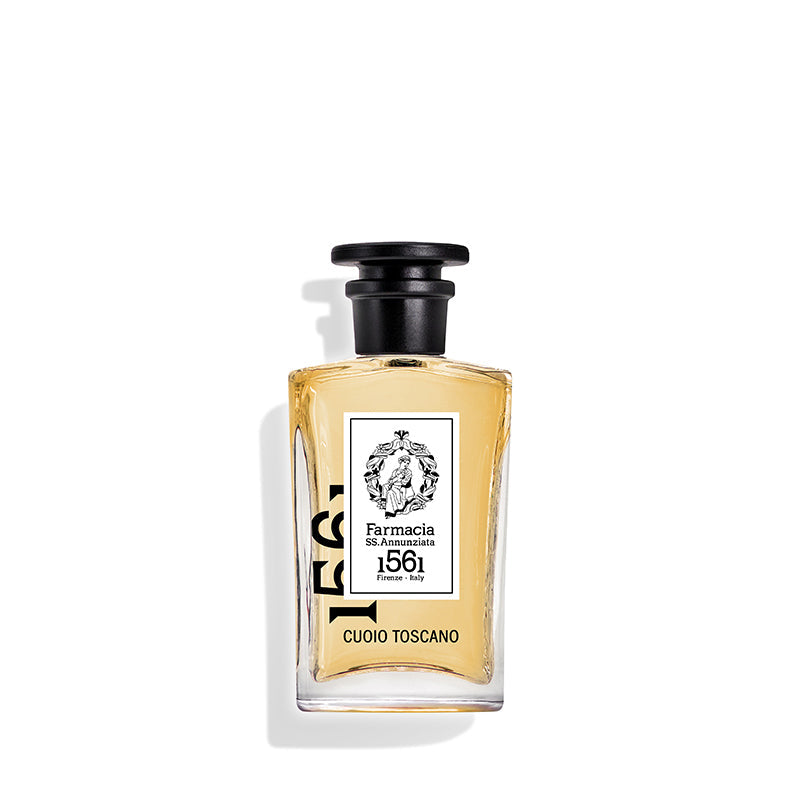 Cuoio Toscano Eau de Parfum by Farmacia SS. Annunziata 1561 features a clear glass bottle with light amber liquid, black cap, and white label, evoking a refined leather scent for true fragrance connoisseurs.
