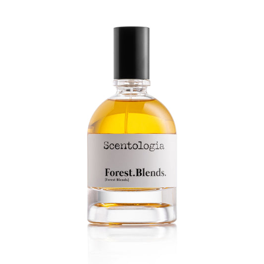 A clear glass bottle of Scentologia's Forest.Blends. Eau de Parfum with amber liquid, black cap, and white label rests on a plain white background—ideal for fans of woody scents.