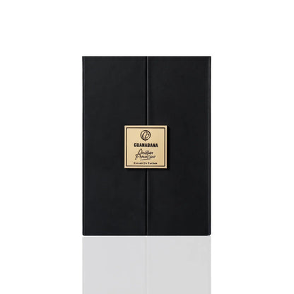 A sleek black box with a gold square label reading "Guanabana Extrait de Parfum - Christian Provenzano" sits against a plain white background, reflecting the fragrance's elegant, Oriental Spicy character.