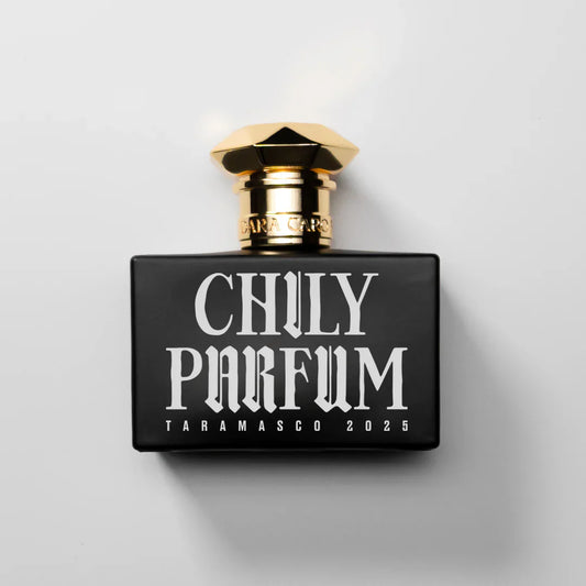 fragrance bottle  on white background .Black and gold cap.White lettering  brand Dara Caro CHILY PARFUM TARAMASCO 2025