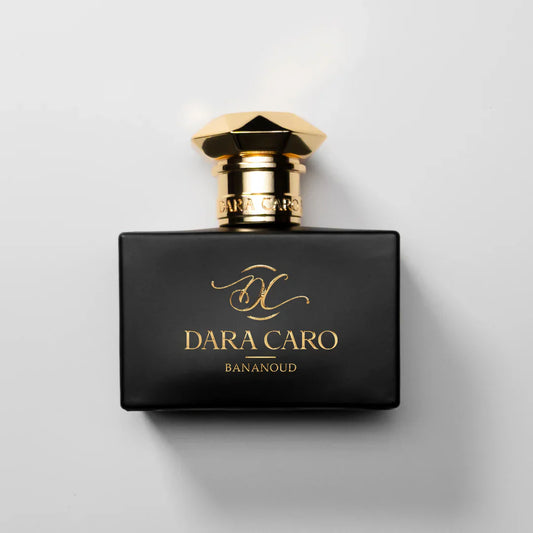 fragrance bottle  on white background .Black and gold cap & lettering  brand Dara Caro BANAOUD