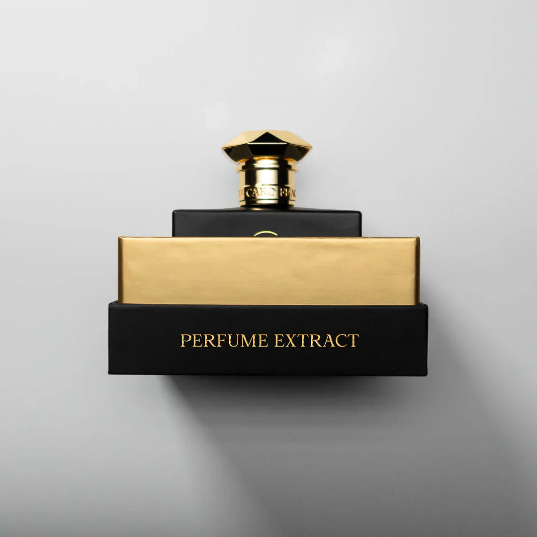 Black and gold lettering  fragrance box on white background brand Dara Caro  Perfume Extract