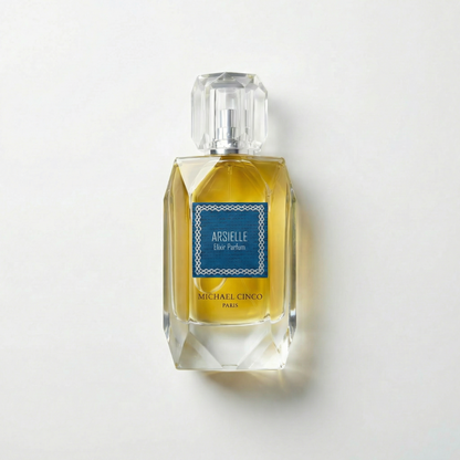 Perfume bottle labeled 'Arsielle' by Michael Cinco on a light gray background