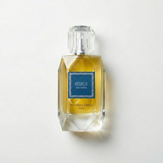 Perfume bottle labeled 'Arsielle' by Michael Cinco on a light gray background