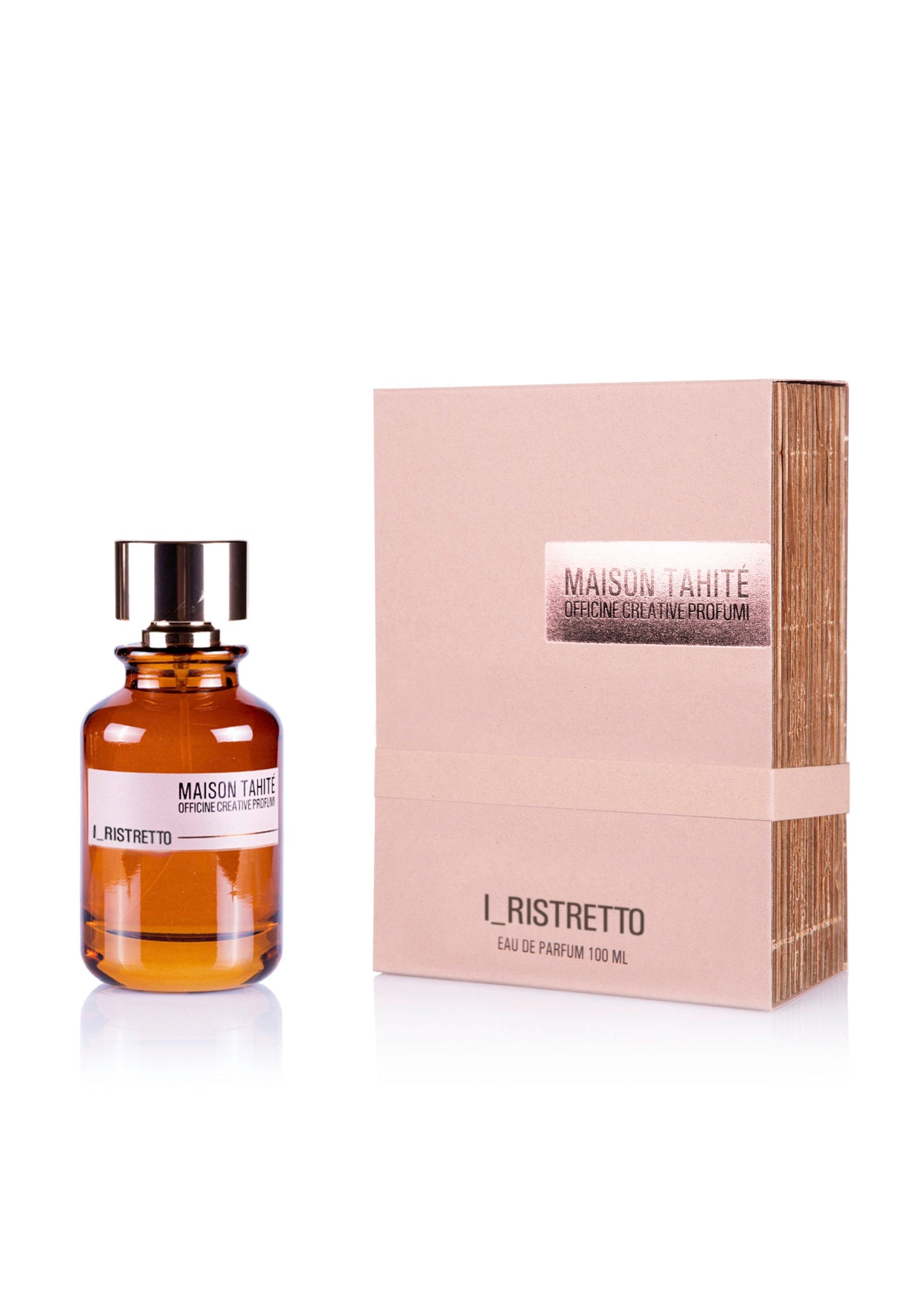 An amber glass bottle of I Ristretto Eau de Parfum by Maison Tahite with a black cap sits beside its light brown box, featuring metallic "Maison Tahite" lettering and highlighting notes of Coffee Absolute Arabica and Iris.