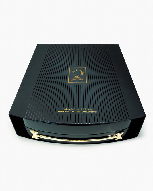 A luxurious black box with gold accents and Arabic text, labeled Immortal Allure Collection Gift Set by Hind Al Oud, displayed against a white background.