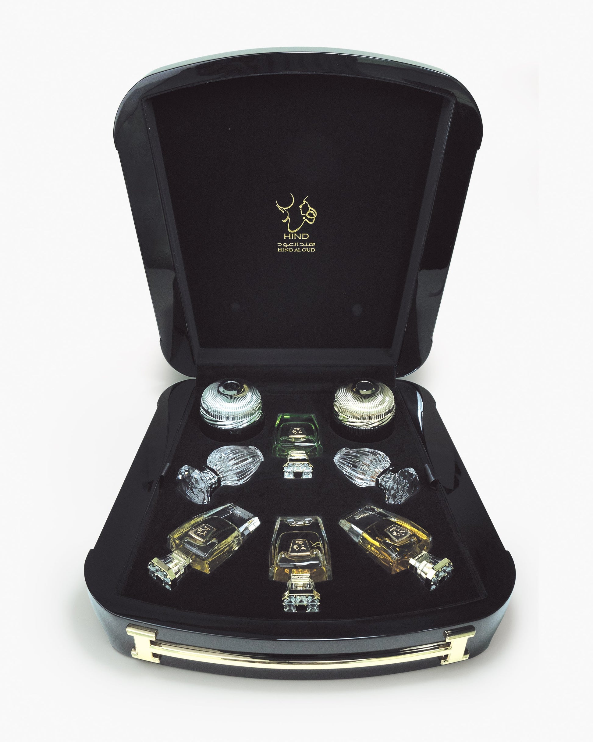 The Immortal Allure Collection Gift Set by Hind Al Oud features a black case with gold hinges displaying individually slotted Aliya'E Parfum and Barari Parfum bottles. The lid showcases a gold logo and Arabic script.