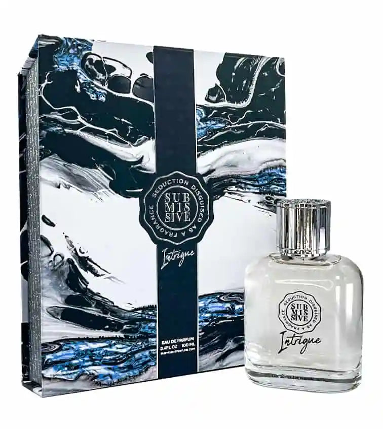A bottle of Submissive Intrigue Eau de Parfum by Submissive Perfume is shown with its matching black, white, and blue abstract box. Bergamot and sandalwood notes echo the bold branding on both packaging and bottle.