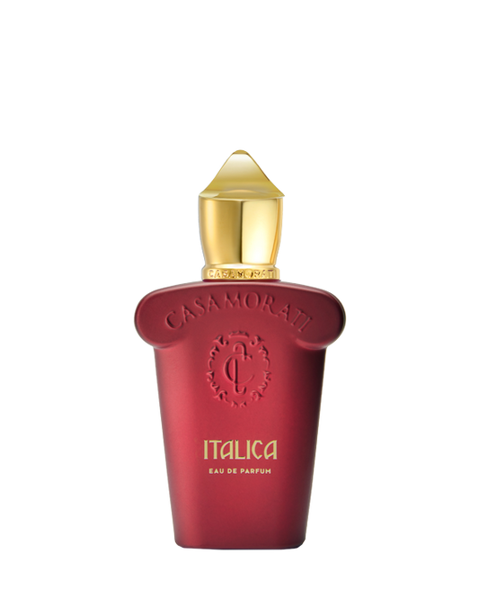 A red bottle with a gold cap and embossed “Casamorati” logo showcases Italica Eau de Parfum - Xerjoff by Fragrapedia Haus, suggesting a luxurious Italian almond fragrance against a white background.
