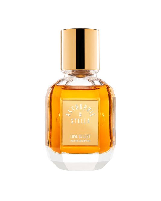 Perfume bottle with gold cap and label on a white background 'Astophil & Stella Love is Lost'