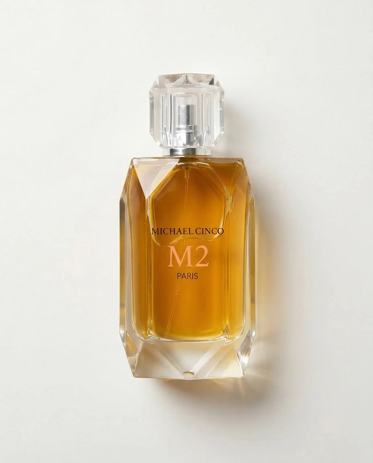 Perfume bottle labeled 'M2' by Michael Cinco on a white background