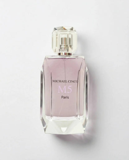 Perfume bottle with pink label on a light gray background MICHAEL CINCO M5