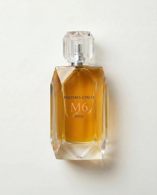 Perfume bottle labeled 'M6' by Michael Cinco on a light gray background