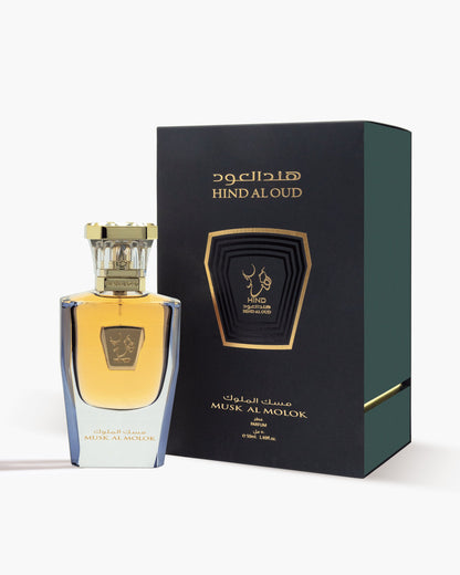 A bottle of Hind Al Oud Musk Al Molok Parfum with a gold cap is displayed beside its dark green, gold-accented box, both showing the brand and product name in Arabic and English.
